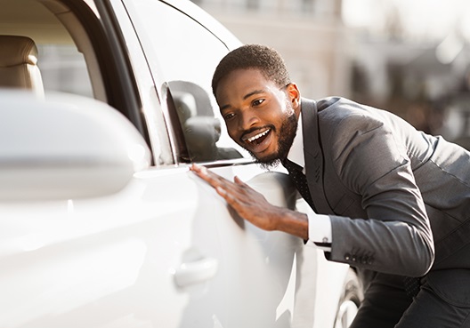 A young man admiring a car