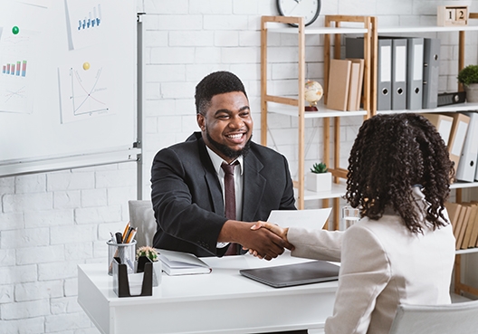 A man shaking a woman's hand