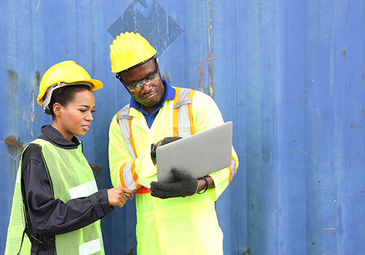 two construction worker collaborating while look at a file