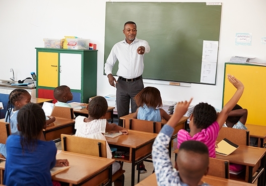 A teacher teaching her students in a classroom
