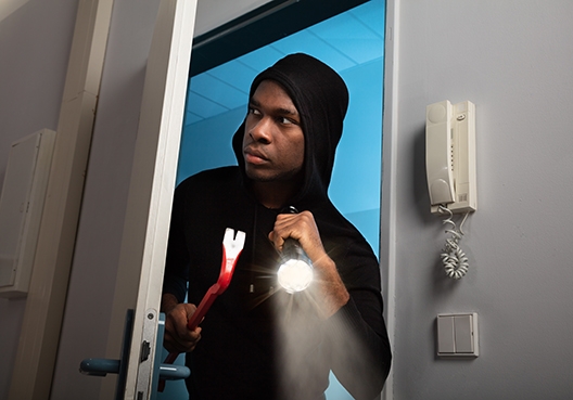 A burglar breaking in
