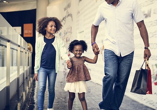 Elimika Education Plan father walking with his two daughters
