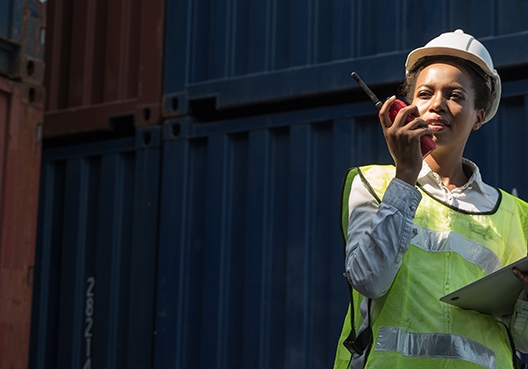 construction worker talking into a walkie talkie