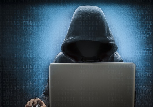 Worker in front of laptop but his face is hidden