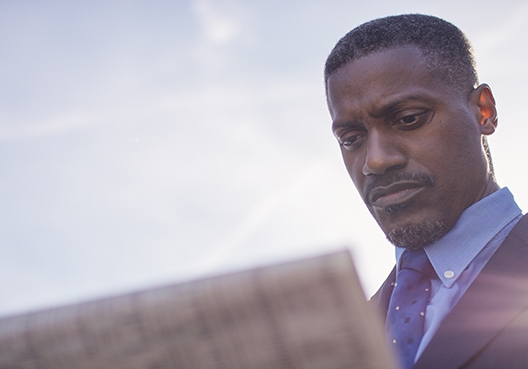 A man looking at a newspaper