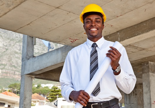 construction worker holding blueprints